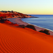 Where red sand meets the ocean at Shark Bay